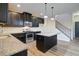 A well-lit kitchen with a large island, stainless appliances, and dark wood cabinets at 3480 Buffington Ln, Cumming, GA 30040