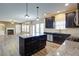Kitchen with dark cabinets, granite countertops, stainless appliances, and an open-concept layout at 3480 Buffington Ln, Cumming, GA 30040