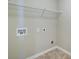 This functional laundry area has tiled floors, hookups, and built-in shelving at 3480 Buffington Ln, Cumming, GA 30040