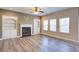 Spacious living room with a fireplace, built-in shelving, and ample natural light at 3480 Buffington Ln, Cumming, GA 30040