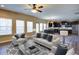 Inviting living room with modern decor, an open floor plan, and a view into the kitchen at 3480 Buffington Ln, Cumming, GA 30040