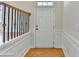 Inviting foyer with hardwood floors, white wainscoting, and stylish staircase at 6046 China Rose Ln, Duluth, GA 30097