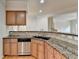 Kitchen bar with granite countertops and stainless steel dishwasher overlooking the breakfast nook at 6046 China Rose Ln, Duluth, GA 30097