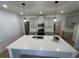 A kitchen island with quartz countertops, stainless steel sink, and pendant lighting at 3047 Abelia Dr, Buford, GA 30519