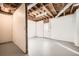 Unfinished basement space with concrete flooring, door, and exposed rafters at 4279 Castle Pines Ct, Tucker, GA 30084