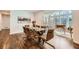 Elegant dining room featuring a glass-top table with seating for six and a sunroom at 4279 Castle Pines Ct, Tucker, GA 30084