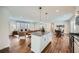 Open-concept kitchen with granite countertops, stainless steel appliances, and sight lines to living and dining area at 4279 Castle Pines Ct, Tucker, GA 30084