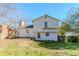 The back exterior of the house is bright with green yard and a door to a patio space at 4821 Mainstreet Valley Trce, Stone Mountain, GA 30088