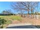 A well-maintained backyard featuring a wooden fence, trees, and green grass offers a private outdoor space at 4821 Mainstreet Valley Trce, Stone Mountain, GA 30088