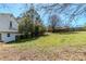 The backyard showcases a fenced-in yard and mature trees, providing plenty of space for outdoor activities at 4821 Mainstreet Valley Trce, Stone Mountain, GA 30088