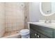 This bathroom features a tiled shower and a modern vanity with a white countertop and a sleek faucet at 4821 Mainstreet Valley Trce, Stone Mountain, GA 30088