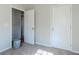 Cozy bedroom featuring neutral walls and trim, with a partially visible doorway to another room at 4821 Mainstreet Valley Trce, Stone Mountain, GA 30088