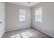 A well-lit bedroom with two windows and neutral walls offers a cozy space to relax and unwind at 4821 Mainstreet Valley Trce, Stone Mountain, GA 30088