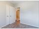 Bedroom with neutral paint, carpet floors, closet and access to other rooms at 4821 Mainstreet Valley Trce, Stone Mountain, GA 30088