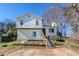 Two-story home featuring white siding, front stairs, and an unfinished front yard at 4821 Mainstreet Valley Trce, Stone Mountain, GA 30088