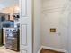 View of the laundry room from the kitchen, with wire shelving and hardwood floors at 4821 Mainstreet Valley Trce, Stone Mountain, GA 30088