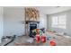 Cozy living room featuring a stone fireplace, a window, carpeted floors, and neutral colored walls at 4821 Mainstreet Valley Trce, Stone Mountain, GA 30088