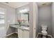 Powder room boasts granite countertops and wood-look floors at 5446 Waterfall Ct, Atlanta, GA 30349