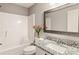 Bathroom features a white vanity with granite counters and a shower tub combination at 5446 Waterfall Ct, Atlanta, GA 30349