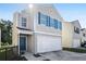 Charming two-story home with blue shutters, a white garage door, and a well-maintained lawn at 5446 Waterfall Ct, Atlanta, GA 30349