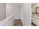 Hallway leading to the bathroom, showcasing the home's modern, wood-look flooring at 5446 Waterfall Ct, Atlanta, GA 30349