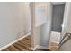 A hallway shows wood look floors, neutral paint, and white trim, illuminated by overhead lighting at 5446 Waterfall Ct, Atlanta, GA 30349