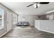 Staged living room with gray walls, updated ceiling fan, and view of the kitchen peninsula at 5446 Waterfall Ct, Atlanta, GA 30349