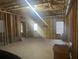 Unfinished basement with exposed beams and natural light from a window at 9996 Village South Dr, Douglasville, GA 30135