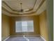 Bedroom with tray ceiling, neutral color walls, carpet flooring, and a ceiling fan at 9996 Village South Dr, Douglasville, GA 30135