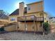 Backyard view of the house with a wooden deck and yard at 9996 Village South Dr, Douglasville, GA 30135