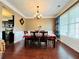 Dining area with hardwood floors, chandelier, and a view into the kitchen at 101 Talking Leaves Ct, Acworth, GA 30101