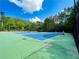 Tennis courts surrounded by lush green trees and blue skies make for a great place to play tennis at 101 Talking Leaves Ct, Acworth, GA 30101