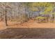 The backyard includes a large open yard with beautiful mature trees at 3420 Lineview Dr, Ellenwood, GA 30294