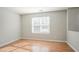 Bright bedroom with hardwood floors and a large window offering plenty of natural light at 3420 Lineview Dr, Ellenwood, GA 30294
