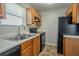 Well-lit kitchen featuring wooden cabinets, black appliances, and a double sink at 3420 Lineview Dr, Ellenwood, GA 30294