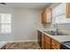 Bright kitchen featuring wooden cabinets, a double sink, and natural light at 3420 Lineview Dr, Ellenwood, GA 30294