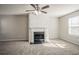 Bright living room with a decorative fireplace, neutral carpet, and ample natural light at 3420 Lineview Dr, Ellenwood, GA 30294