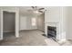 Cozy living room featuring a classic fireplace, ceiling fan, and neutral tones at 3420 Lineview Dr, Ellenwood, GA 30294
