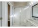 Bathroom with white tile shower, glass doors, vanity and patterned mirror at 1057 Regent Sw St, Atlanta, GA 30310