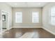 Bright bedroom featuring hardwood floors, two windows, and neutral paint at 1057 Regent Sw St, Atlanta, GA 30310