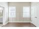 Bedroom with hardwood floors, two windows, and an entry to a bathroom at 1057 Regent Sw St, Atlanta, GA 30310