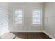 Bedroom with two windows, custom wall trim, and hardwood floors at 1057 Regent Sw St, Atlanta, GA 30310