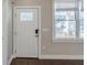 Bright entryway featuring a glass paneled front door, a window and wood floors at 1057 Regent Sw St, Atlanta, GA 30310