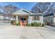 Charming blue home featuring red shutters, a spacious driveway and welcoming porch at 1057 Regent Sw St, Atlanta, GA 30310