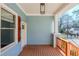 Inviting front porch featuring painted wood ceiling, wood decking, and modern light fixture at 1057 Regent Sw St, Atlanta, GA 30310