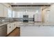 Modern white kitchen featuring an island, stainless appliances, and decorative backsplash at 1057 Regent Sw St, Atlanta, GA 30310