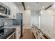 Bright kitchen with stainless steel appliances, white cabinets, and a large granite island at 1057 Regent Sw St, Atlanta, GA 30310