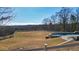 A spacious backyard with inground pool, stone patio, and picturesque tree-lined landscape at 2150 Fincher Rd, Canton, GA 30114