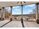 Backyard view featuring an in-ground pool, mature trees, white fencing and a covered patio at 2150 Fincher Rd, Canton, GA 30114