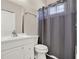 Clean bathroom featuring a white vanity and a shower with a gray curtain for a modern aesthetic at 2150 Fincher Rd, Canton, GA 30114